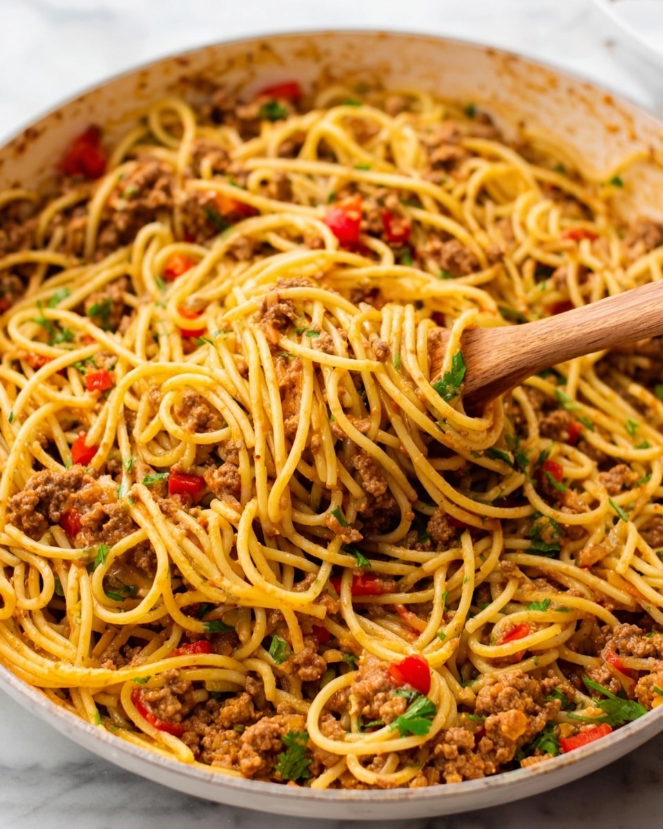 This image shows a close-up of a plate filled with spaghetti mixed with ground meat, red bell peppers, and melted orange-yellow cheese on top. The spaghetti noodles are coated with a light sauce and are tangled together with pieces of cooked meat and small chopped peppers. A silver fork, held by a woman's hand, is lifting some spaghetti and meat from the plate. The plate is white and sits on a white marbled surface. The colors are warm and inviting, with the orange cheese melting nicely over the pasta and meat. photo taken with an iphone --ar 4:5 --v 7