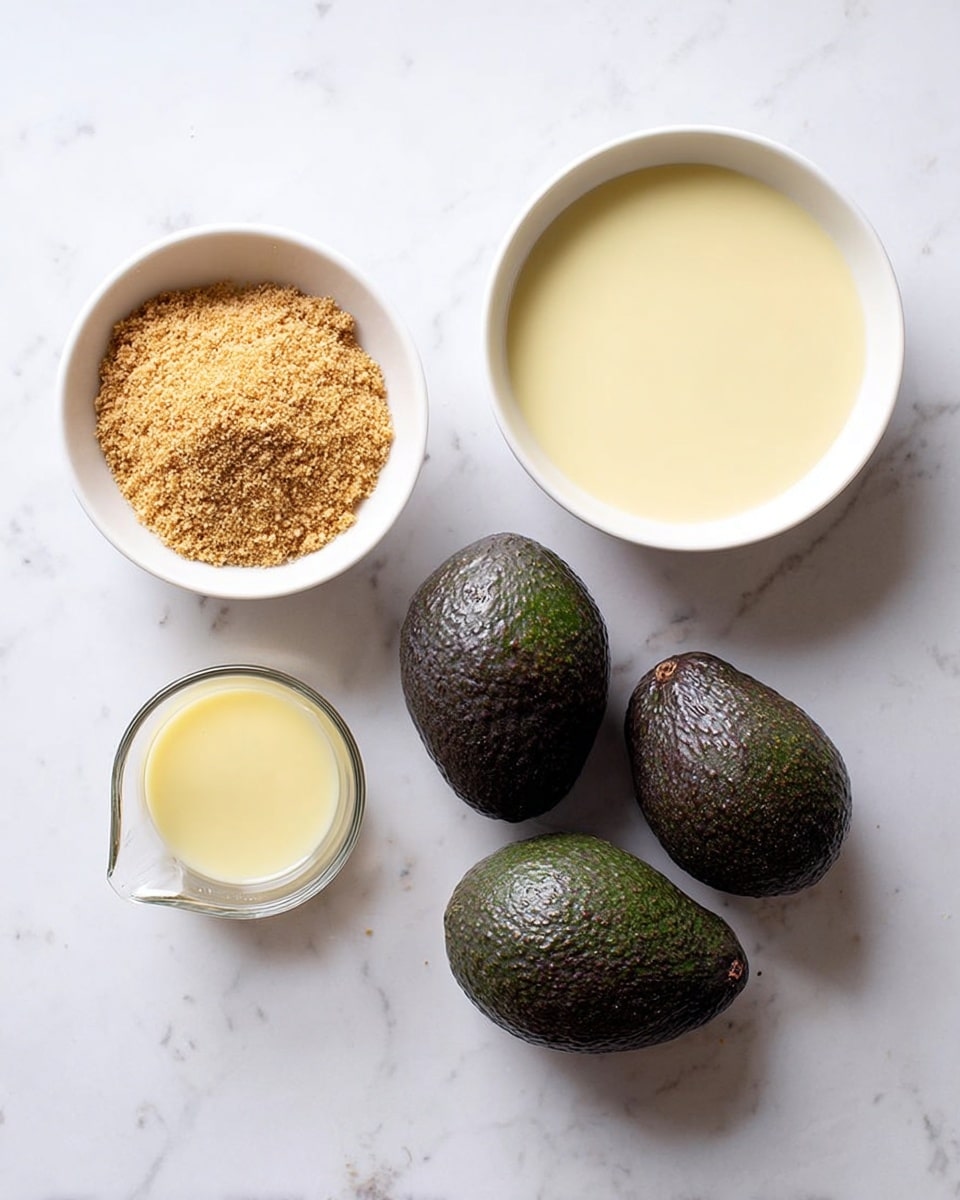 The image shows five items placed on a white marbled surface. On the left, there is a white bowl filled with a crumbly, golden-brown powder. Next to it, three whole, dark green avocados with rough skin are arranged in a small cluster. To the right of the avocados, there is a large white bowl filled with a smooth, pale yellow liquid. In front of the large bowl, a small clear glass measuring cup holds a lighter yellow liquid. The items are spaced so that each stands out clearly with no overlap. photo taken with an iphone --ar 4:5 --v 7