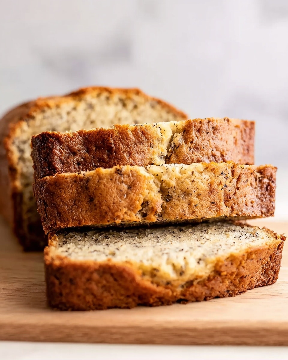 The image shows three slices of bread with a golden brown crust and a soft, light beige inside with small black specks. The bread slices are stacked unevenly with the front slice lying flat, the second slice leaning against it, and the third slice slightly blurred in the background. The surface beneath the bread is a white marbled texture. The focus is sharp on the front slice, showing the bread’s soft texture and crisp crust clearly, while the background is softly blurred. photo taken with an iphone --ar 4:5 --v 7