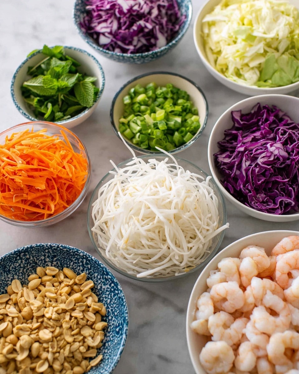 The image shows nine small white bowls arranged on a white marbled surface, each filled with different fresh ingredients. At the center front, there is a bowl full of thin white noodles. To its right, a bowl contains light pink small shrimp. Next to the shrimp bowl on the right edge is a white bowl holding chopped green herbs. In front and to the left of that, a clear glass bowl holds tan roasted peanuts. At the front left, a blue-white patterned bowl is filled with bright orange shredded carrots. Behind that, a white bowl has fresh green mint leaves. To the left and slightly behind the noodle bowl, a small white bowl contains chopped green onions. Behind it, a blue patterned bowl is filled with chopped white and light green cabbage. Next to that, another white bowl is filled with shredded purple cabbage. Behind the purple cabbage bowl, a white bowl holds white bean sprouts. All bowls and ingredients are vividly colored and neatly arranged. Photo taken with an iphone --ar 4:5 --v 7