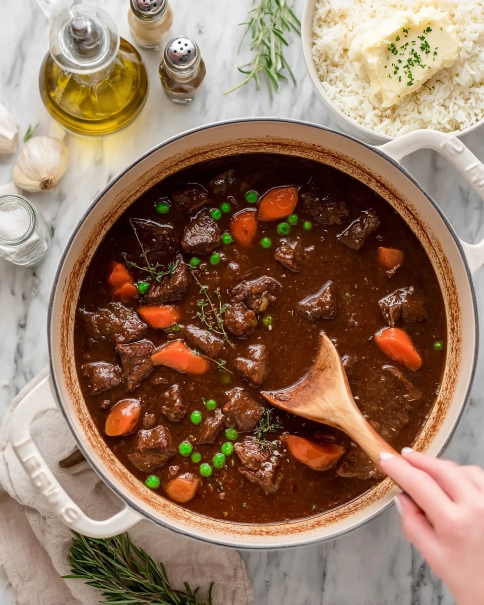 A white bowl filled halfway with mashed potatoes, which are creamy and slightly lumpy, topped with a melting pat of butter and sprinkled with chopped green herbs. Next to the potatoes is a rich brown beef stew with visible chunks of tender beef, whole baby carrots, and green peas in a thick gravy. The bowl sits on a white marbled surface with a sprig of rosemary nearby and a blue-striped cloth at the edge. Photo taken with an iphone --ar 4:5 --v 7