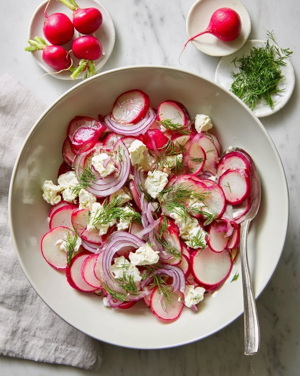 A white bowl filled with a colorful salad that has three main layers: thin, round slices of red and white radishes spread evenly at the bottom, topped with thin, curly slices of light purple onion, and scattered with white cheese chunks. Fresh green dill sprigs are placed on top and mixed throughout, adding bright green bursts. A silver spoon rests inside the bowl on the right side. Near the bowl, there are two small white dishes on a white marbled surface: one with three whole radishes and one with more fresh dill sprigs. Photo taken with an iphone --ar 4:5 --v 7