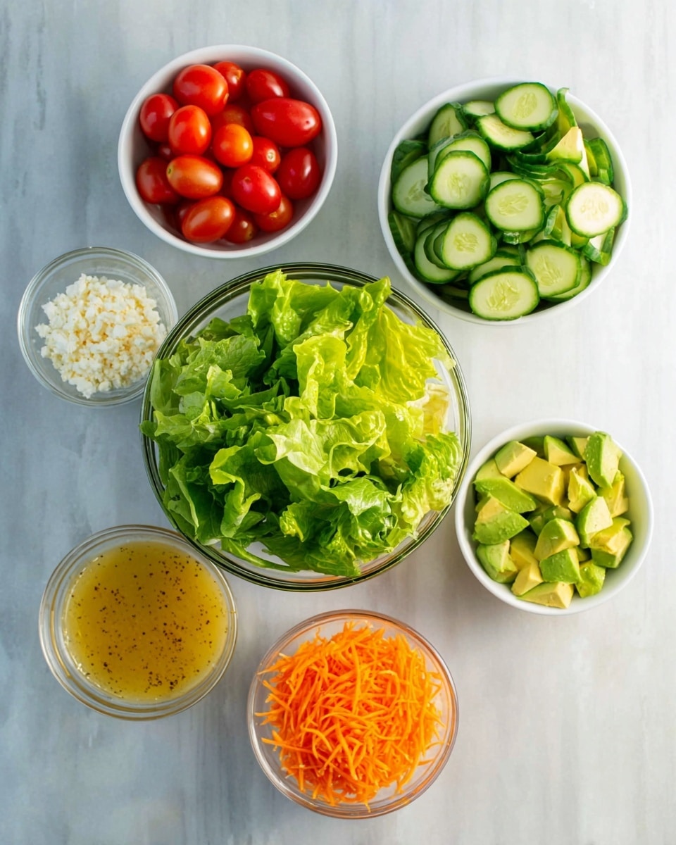 The image shows six small white bowls and one clear glass bowl arranged on a white marbled surface. The clear bowl in the center is full of bright green leafy lettuce with crisp texture. Around it, starting from the top left, there is a white bowl filled with vibrant red cherry tomatoes cut in halves, next to it a bowl with sliced green cucumbers. Below the cucumber bowl is a clear glass bowl with a golden yellow salad dressing that has a smooth texture with visible spices. To the right of the lettuce bowl is another white bowl with chopped avocado pieces, showing a fresh light green color. Below the avocado is a small glass bowl filled with shredded bright orange carrots. To the left of the carrots is a small white bowl containing crumbly white cheese. photo taken with an iphone --ar 4:5 --v 7