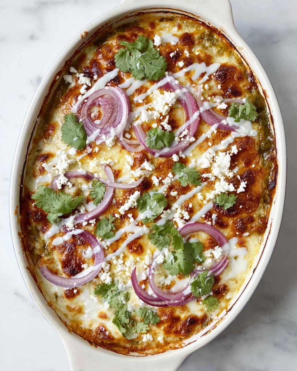 A white oval baking dish filled with a baked layered dish showing a golden-brown melted cheese top layer with some browned spots. Thin rings of purple onions are spread across the surface along with white cheese crumbles and fresh green cilantro leaves. There are also some drizzles of white sauce over the top, and the dish sits on a white marbled surface. photo taken with an iphone --ar 4:5 --v 7