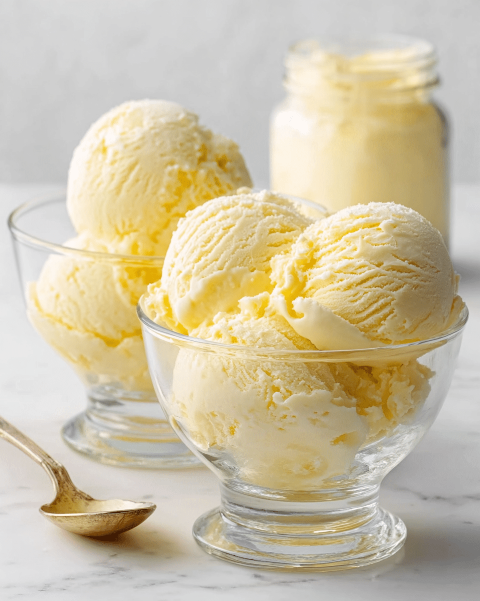 A small white ramekin filled with two creamy, pale yellow scoops of ice cream, topped with tiny round rainbow sprinkles in colors like red, blue, yellow, green, and pink. A silver spoon is placed inside the ramekin, standing upright. The ramekin rests on a white marbled textured surface, next to a folded light blue towel. The ice cream slightly melts on the edges, showing smooth texture photo taken with an iphone --ar 4:5 --v 7