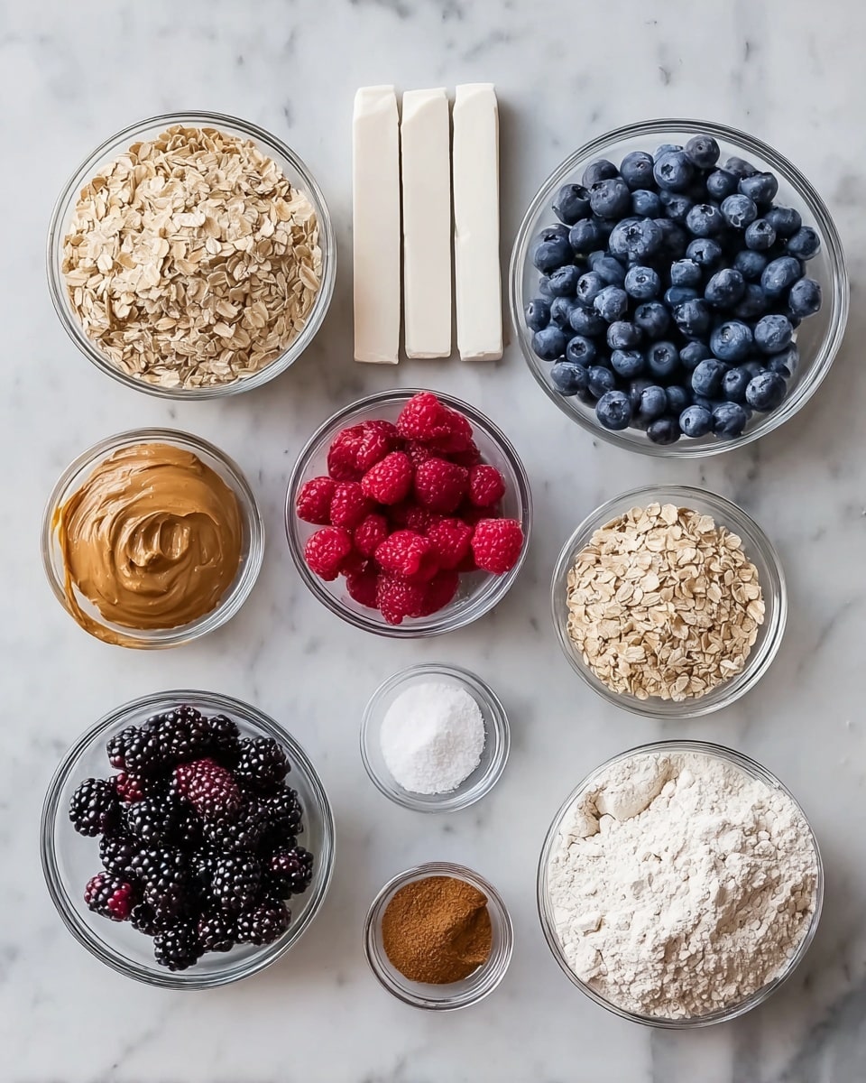 The image shows several clear glass bowls and three white rectangular sticks arranged neatly on a white marbled surface. There is a large bowl filled with white flour on the right side, next to it is a medium-sized bowl with fresh blueberries that are dark blue and round. In the center, a medium bowl holds bright red raspberries, and below it is a smaller bowl filled with blackberries, which are textured and dark purple-black. To the left, a large bowl contains rolled oats that are light brown and flaky, and below it is a bowl with smooth brown peanut butter. Smaller bowls hold white granulated sugar, ground cinnamon, and ground nutmeg, all in fine powder form. The three white rectangular sticks are stacked horizontally above the bowls. photo taken with an iphone --ar 4:5 --v 7