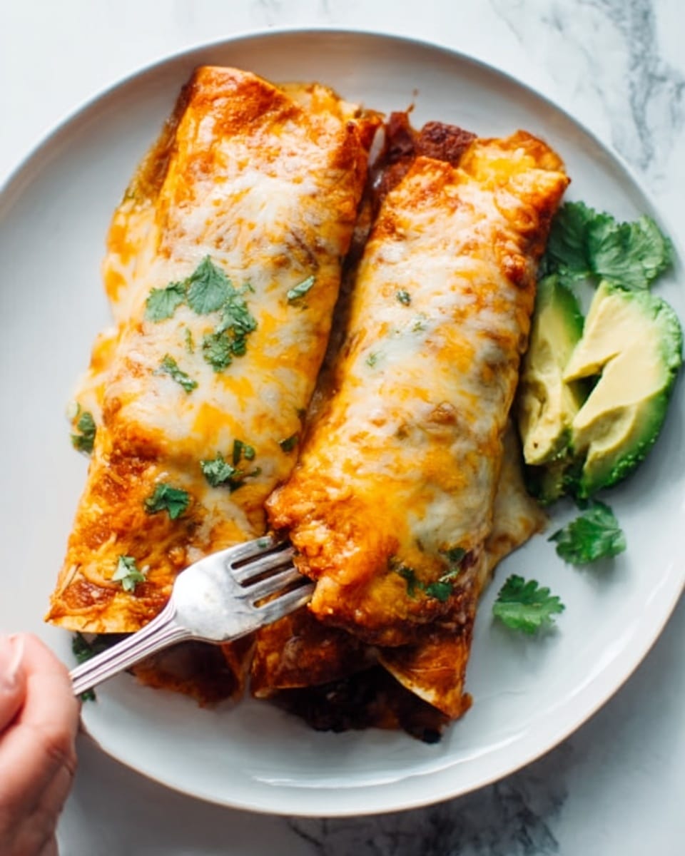 The image shows two folded enchiladas placed side by side on a white plate. Each enchilada is covered with a melted light golden cheese layer that appears slightly bubbly and textured. Under the cheese, hints of a warm orange and reddish sauce peek through. The enchiladas rest on a white marbled surface. Small green cilantro leaves decorate the side, adding a fresh contrast. A slice of green avocado sits near the bottom right edge of the plate. A silver fork is held by a woman's hand, touching the closer enchilada's edge, ready to take a bite. photo taken with an iphone --ar 4:5 --v 7