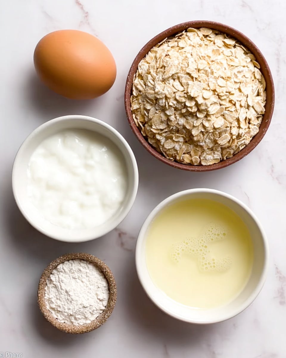 The image shows five separate ingredients arranged on a white marbled surface. At the top right, there is a small brown bowl full of light beige rolled oats with a rough texture. To the left of it is a plain brown egg with a smooth shell. Below the egg is a white bowl filled with thick white yogurt. To its right, another white bowl holds a pale yellow liquid with some bubbles on the surface. At the bottom left sits a tiny rough-textured brown bowl containing a small pile of white powder. The composition is simple and neat, with the different textures and colors clearly visible. photo taken with an iphone --ar 4:5 --v 7