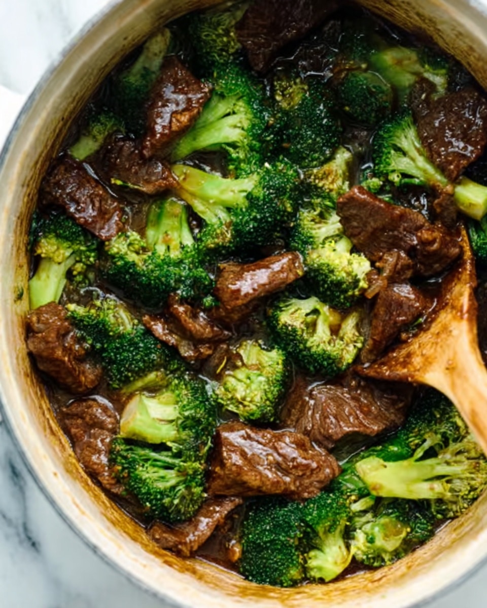 A white slow cooker filled with a dark brown broth containing tender, thin slices of beef and small bright green broccoli florets. The broth looks rich and slightly glossy with bits of chopped green onions floating around. A wooden spoon is lifting a piece of beef with a broccoli floret and a green chili slice above the liquid. The inside of the cooker shows some stains from the broth. The background is a white marbled surface photo taken with an iphone --ar 4:5 --v 7