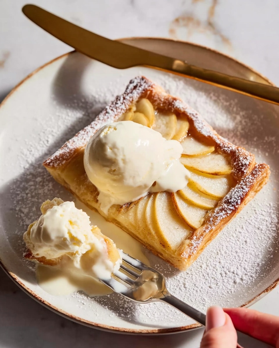 A square piece of golden brown pastry with a flaky crust is topped with thinly sliced, cooked light yellow apples arranged neatly in overlapping rows. On top of the tart and around it, there is melting white cream or ice cream, creating soft pools mixing into the golden apples. The edges of the pastry are dusted lightly with white powdered sugar. A silver fork rests on the tart with some cream on its prongs, and a woman's hand is holding a white plate with a white marbled surface underneath, while a gold knife lies just above the tart. Photo taken with an iphone --ar 4:5 --v 7