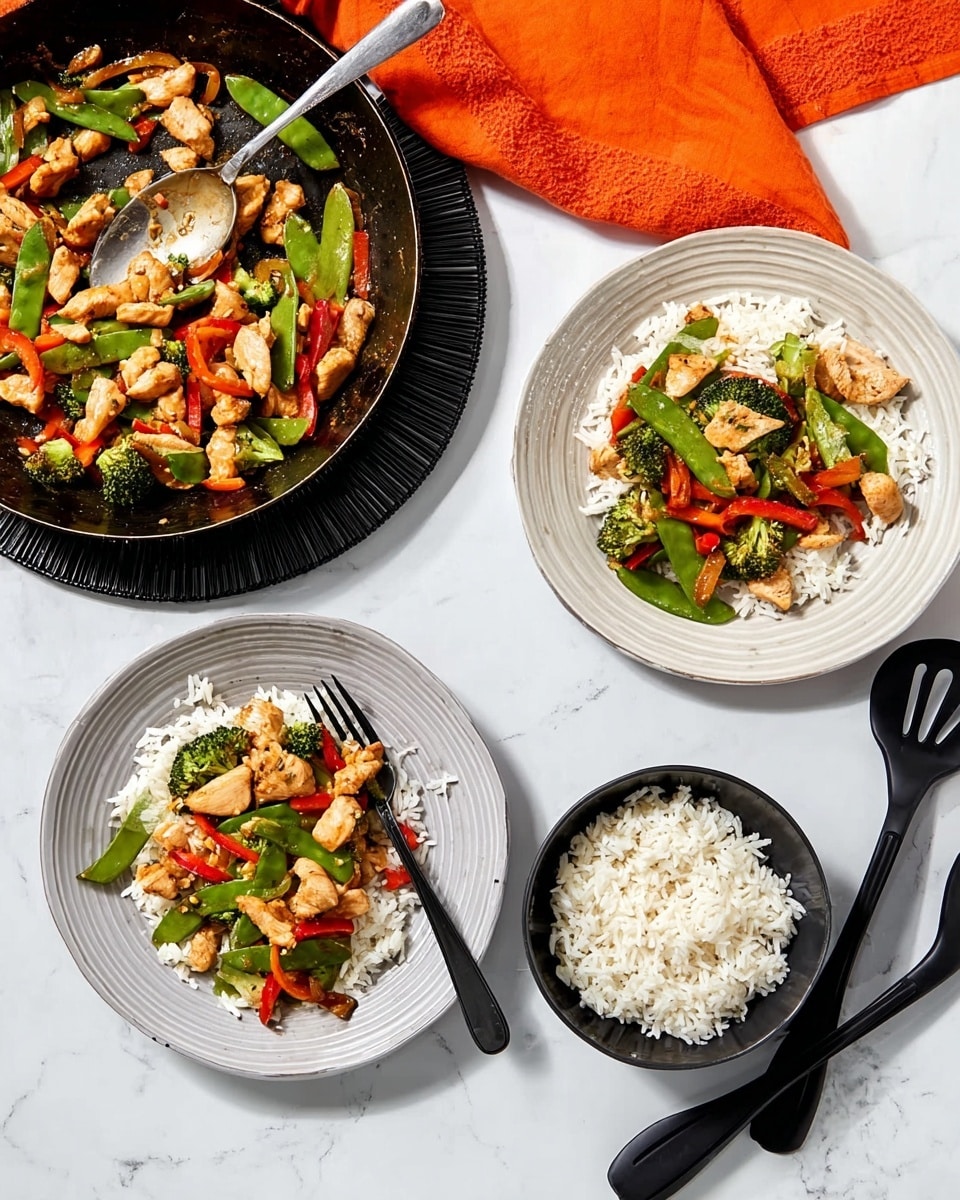 Two white plates each have a layer of white rice topped with a colorful mix of cooked chicken pieces, green snap peas, red bell peppers, and broccoli florets, all sitting on a white marbled surface. A black fork rests on one of the plates. To the upper left, a black pan filled with more chicken and vegetables sits on a black trivet, with a silver spoon inside. Above the pan, an orange cloth adds a pop of color. In the lower right corner, a black bowl is filled with white rice. Beside it are black utensils laid out neatly on the white marbled surface. photo taken with an iphone --ar 4:5 --v 7