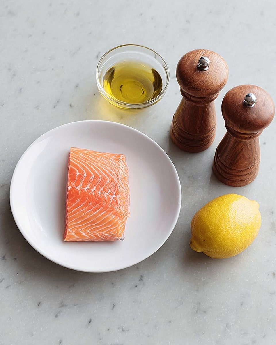 A white plate holds a fresh, raw salmon fillet with a bright orange color and light white lines running through it, placed on a white marbled surface. Next to the plate, there is a small clear glass bowl filled with golden olive oil, a whole yellow lemon, and a pair of wooden salt and pepper grinders with a polished finish. The scene is simple with soft, natural light highlighting the colors and textures of the ingredients photo taken with an iphone --ar 4:5 --v 7