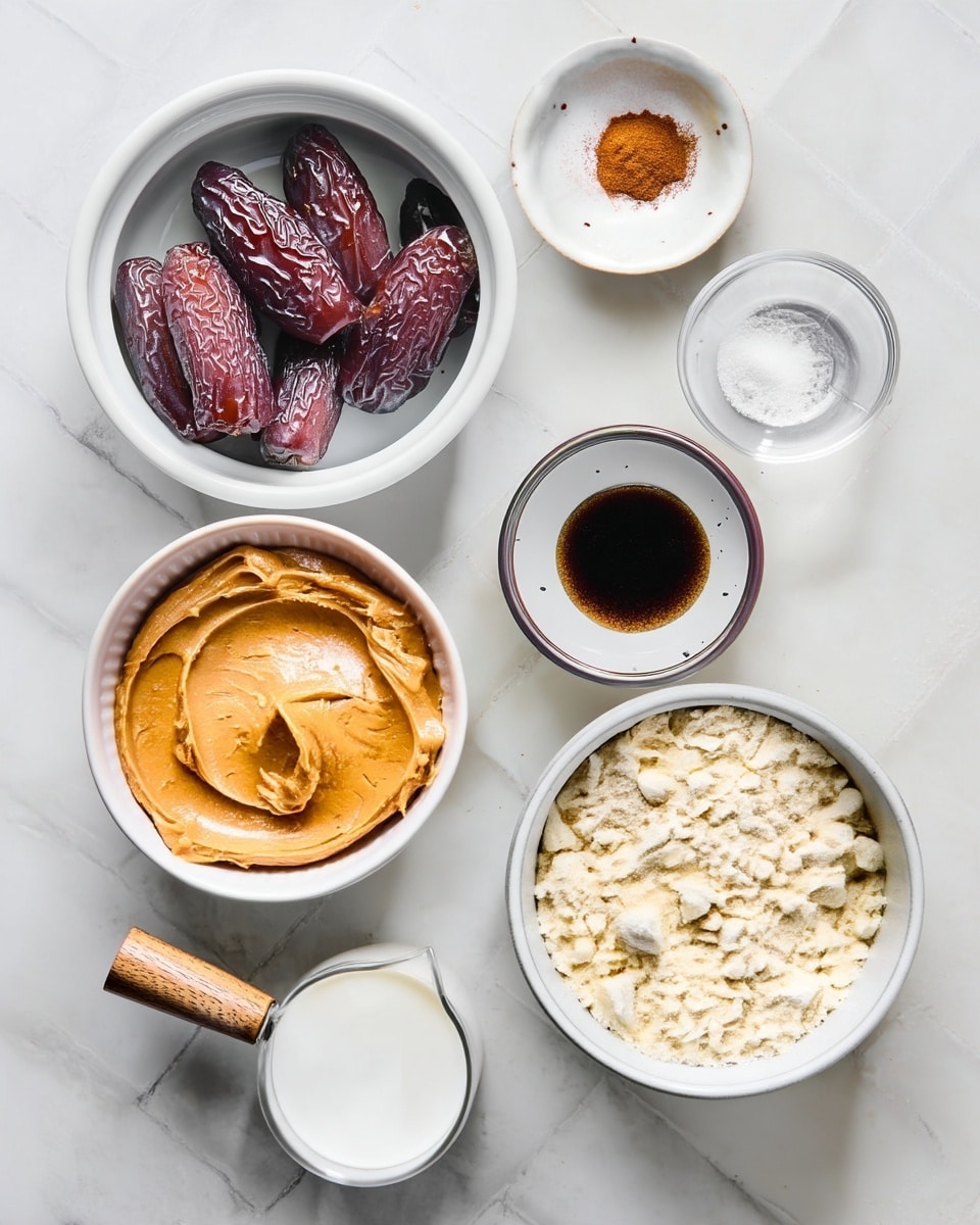 The image shows seven white bowls and a small clear glass jug placed on a white marbled surface. The top left bowl holds seven large dark brown dates with a shiny, wrinkled texture. To the right, a small white bowl contains a small heap of orange-brown powder. Next to it, a small clear bowl holds white granulated salt. Below the dates, a larger white bowl is filled with smooth, light brown peanut butter. In the center right, a white bowl has a dark brown liquid, likely vanilla extract, with speckled spots on the bowl’s rim. The bottom right bowl is filled with pale yellow powdery flour. At the bottom left, a small clear glass jug with a wooden handle is filled with white milk. Photo taken with an iphone --ar 4:5 --v 7